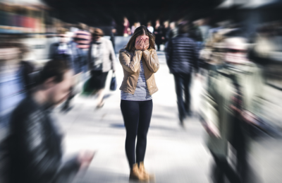 Underwriting Depression - picture of woman with hands over face in crowd