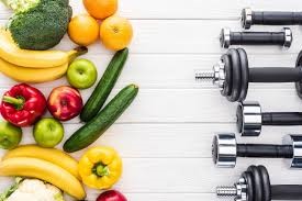 nutrition and exercise fruit and vegetables and weights and dumbbells 