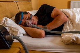man sleeping in CPAP mask
