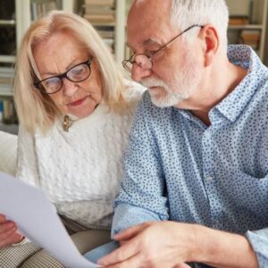 an older couple reading over a document representing clients over 70 considering a life settlement