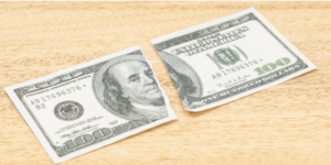 Photo of a $100 bill ripped in half, symbolizing "Split Dollar"