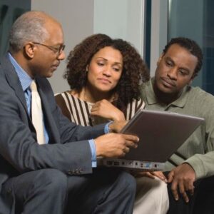 A picture of an advisor with his clients, symbolizing clients having a better understanding of considerations that go into the purchase of life insurance.